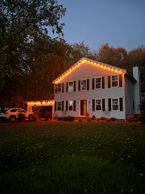 Holiday lighting installation on a residential exterior